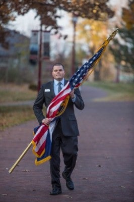 Vet stands with flag