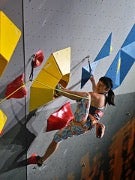 A woman climbing on an indoor climbing wall